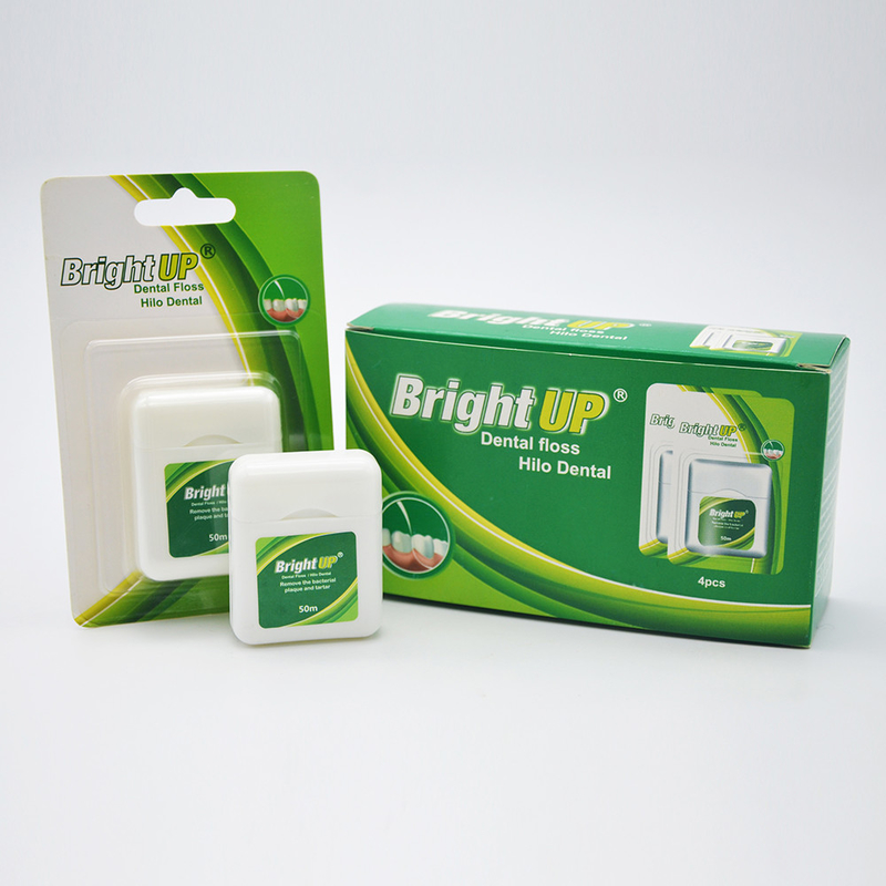 A caixa biodegradável erval de fio dental ou o fio dental escolhem o cuidado oral mantêm-no sorriso