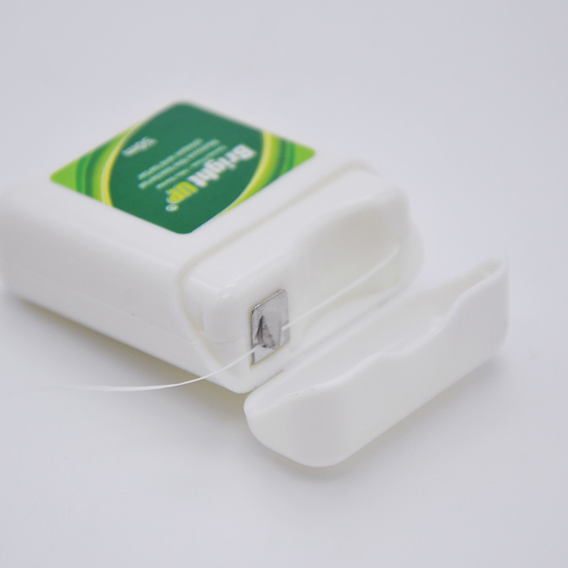 A caixa biodegradável erval de fio dental ou o fio dental escolhem o cuidado oral mantêm-no sorriso