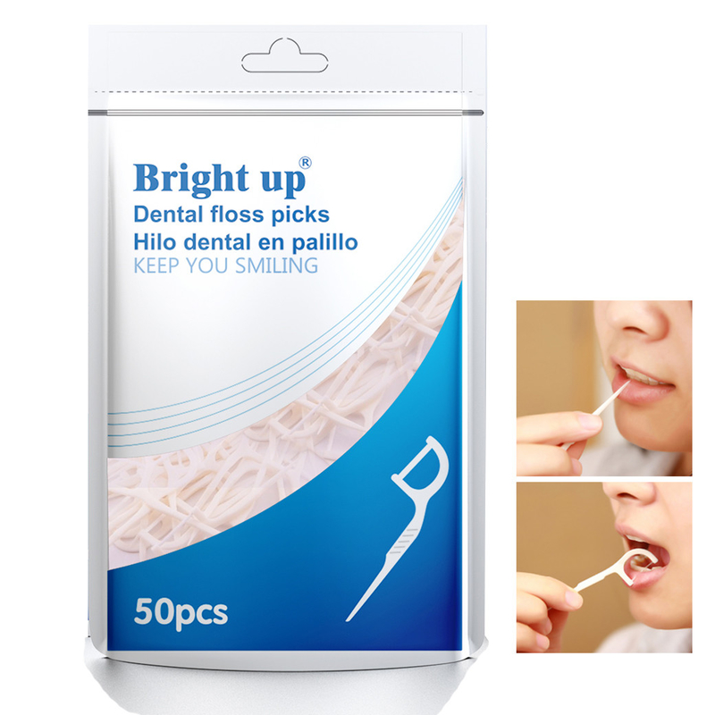A caixa biodegradável erval de fio dental ou o fio dental escolhem o cuidado oral mantêm-no sorriso